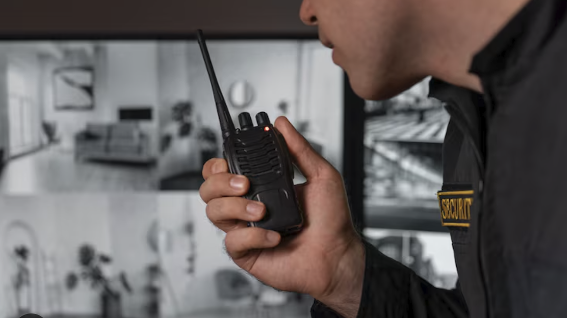 Security officer using DirectPTT radio at monitoring station
